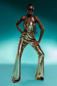 Detail of sequined sleeveless halter jumpsuit with deep V-neck and slim fit waist
