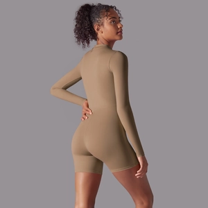 Rear view of tight-fitting khaki long sleeve romper showing sleek athletic silhouette