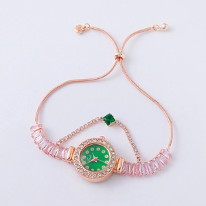 Detail of rose gold bracelet watch with green dial, pink gemstones and crystal chain