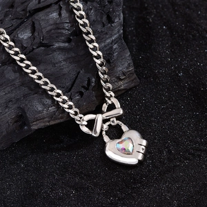 Silver vintage heart lock necklace with iridescent stone and bow tie detail