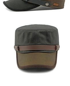 Close-up of contrast color cadet cap featuring side rivets and leather brand patch details