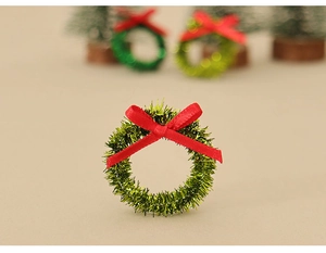 Miniature green Christmas wreath with red bow detail for festive DIY model scenes