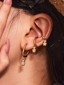 Detailed close-up of gold-plated PVD hoop earrings featuring sparkling zircon crystal charms
