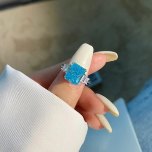 Close-up of S925 silver ring featuring a large brilliant blue zircon stone on a finger