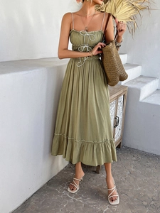 Olive green midi dress with ruffled hem, spaghetti straps and woven straw tote bag