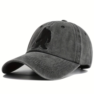 Close-up of Bigfoot silhouette embroidery on washed grey denim baseball cap