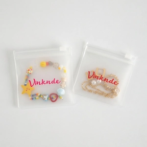 Frosted EVA jewelry storage pouches with zipper containing colorful bracelet and gold earrings