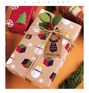 Close-up of Christmas kraft wrapping paper with snowman patterns and rustic gift tags