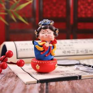 Detailed close-up of a resin Tang style lady figurine on a red drum base with classical props
