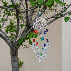 Detail of Tree of Life suncatcher with colorful beads and clear crystal prisms on tree branch
