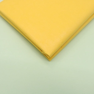 Close-up of bright yellow tissue paper texture for DIY handmade flower crafts and gift wrapping