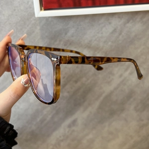 Detail shot of leopard print anti-blue light glasses frame with metallic arrow accents