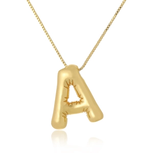 Macro shot of 3D balloon style letter A gold pendant with polished finish and box chain