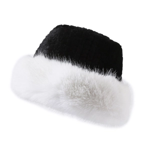 Detail shot of winter plush hat featuring black short fur crown and white faux fur brim