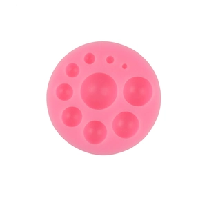Pink circular silicone mold with various sized hemisphere slots for DIY cake baking decoration