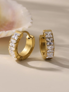 Close-up of gold stainless steel hoop earrings with four square-cut cubic zirconia stones