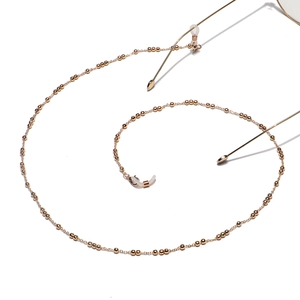 Elegant gold beaded eyewear chain with silicone loops and adjustable metal sliders