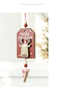 Detail of wooden reindeer ornament with Merry Christmas text and festive red cotton string