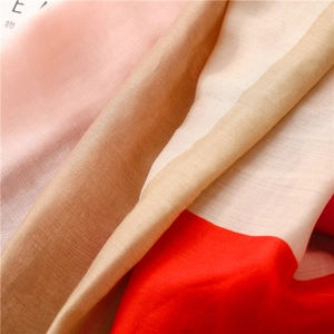Close-up of lightweight pastel patchwork scarf with fine fiber texture and soft drape