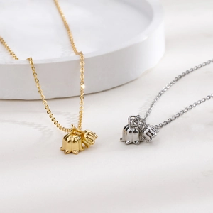 Macro shot showing S925 hallmark on lily of the valley pendants in gold and silver