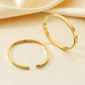 Minimalist gold stainless steel oval hinged bangle bracelets with a polished shiny finish