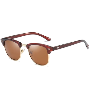 Retro clubmaster sunglasses with brown lenses and golden metal frames at 45-degree angle