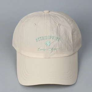 Detail of clover embroidery and Lucky Clover text on quick-dry beige baseball cap