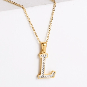 Detailed macro view of 18k gold plated letter L pendant with sparkling zircon inlay