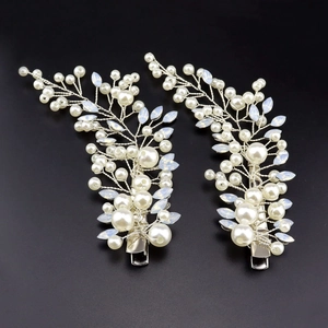 Detail of handmade bridal hair clips with pearls and crystals on silver wire vines