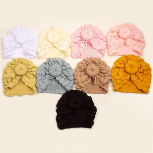 Baby donut turban hats in various solid colors featuring soft waffle textured fabric