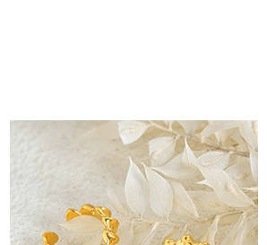 Detailed view of shiny gold-finished heart-shaped ear cuff with polished metallic texture