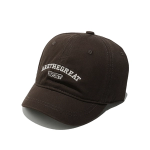 Detailed view of white 3D embroidery ARETHEGREAT SPORT on a dark brown cotton baseball cap