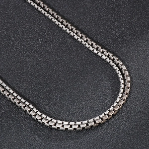 Macro shot of vintage silver-tone stainless steel box chain necklace with aged texture