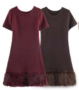 Detail of burgundy and dark brown knit dresses featuring plush faux fur trim at the hem