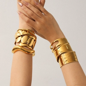 Exaggerated gold stainless steel open bangles set featuring wavy and hammered textures