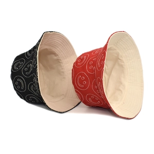 Black and red cotton bucket hats featuring white stitched smiley faces and double layers