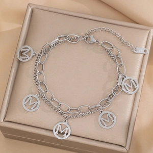 Double-layered silver stainless steel bracelet featuring five circular M letter charms