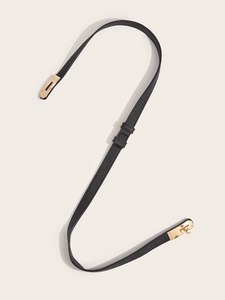 Detail of cross-grain leather skinny belt with golden turn-lock buckle closure