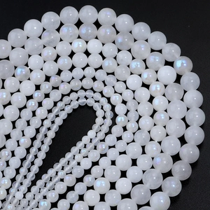 Macro shot of spiral arranged moonstone beads in multiple sizes on black background