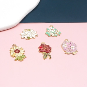 Flat lay of colorful enamel flower charms featuring lily daisy sunflower rose and hydrangea