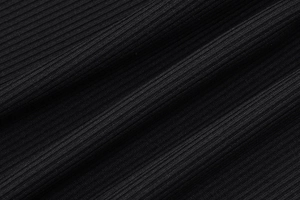 Close-up of black ribbed knit fabric showing fine texture and vertical thickness