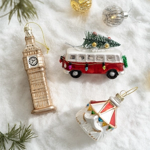Festive Christmas glass ornaments featuring Big Ben, a red vintage bus, and retro figures