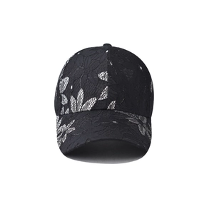 Close-up of black lace floral embroidery texture on a classic baseball cap for women