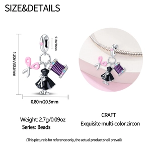 Macro shot of silver sewing charms with pink enamel scissors and multi-color zircons