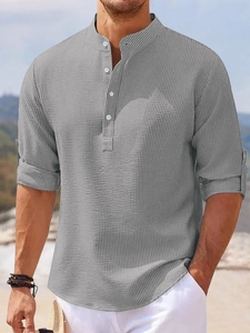 Detail of grey men's waffle texture long sleeve polo shirt with rolled-up sleeve tab