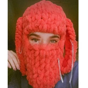 Close-up of coral knit balaclava with silver chains and bunny ears detail