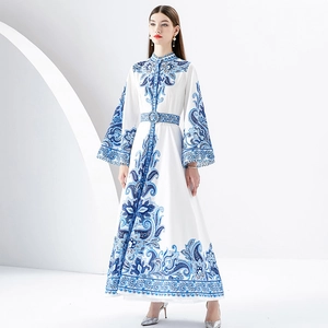Floral A-line maxi dress with mandarin collar and bell sleeves on a model in white studio