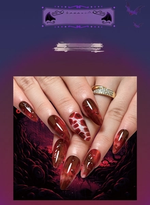 Macro detail of long stiletto Halloween press-on nails with red blood drip art design