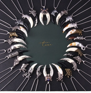 Collection of retro wolf tooth pendants in vintage stainless steel with ethnic tribal carvings