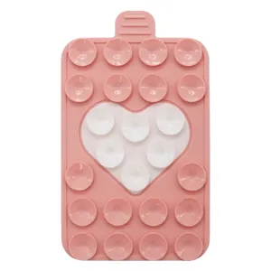 Detail view of pink silicone suction cup phone holder with a white heart-shaped design